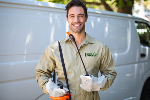 fraleigh pest control employee smiling at camera in uniform